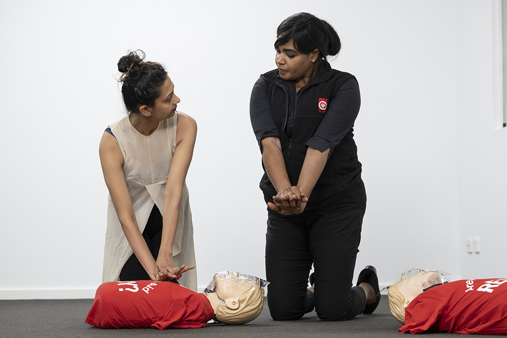 A female learning CPR from a female trainer