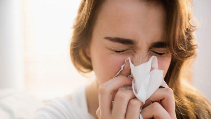 Aussie Flu woman sneezing