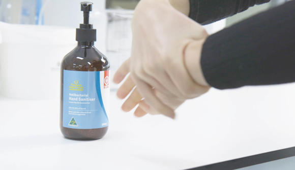 Hands using St John hand sanitiser gel